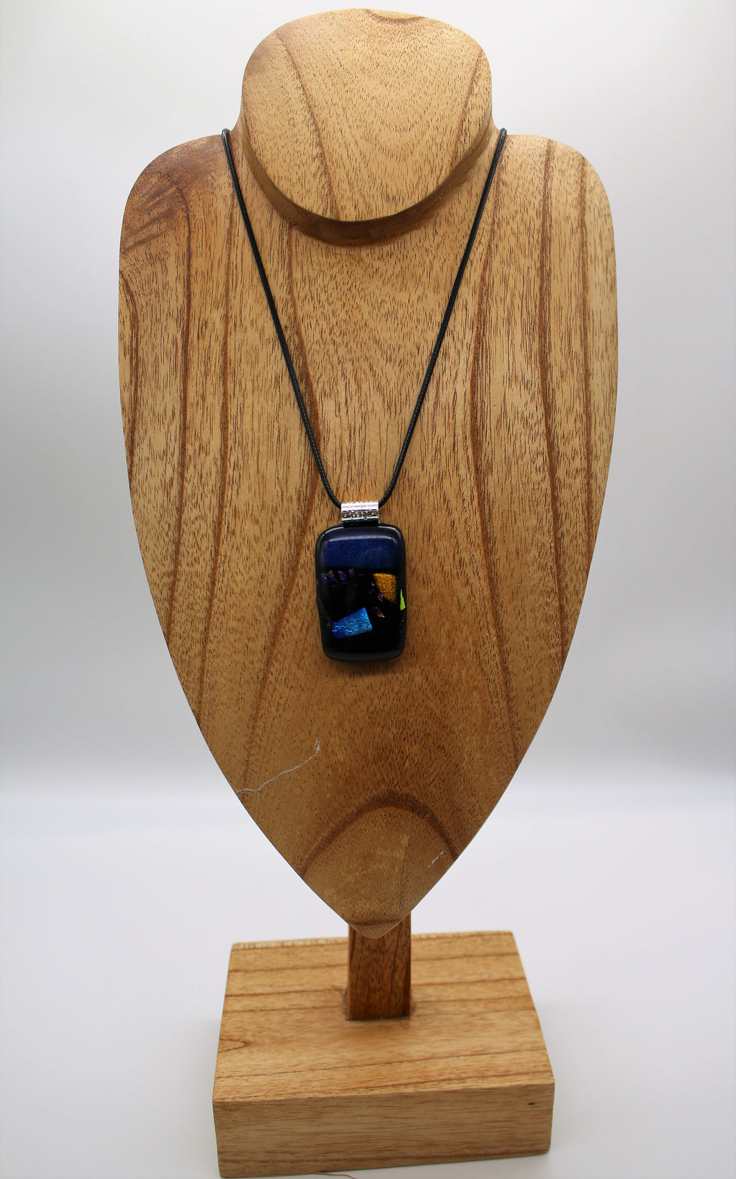 Jewelry - Small Oblong Opaque Black with Varying Color pieces of Dichroic glass embedded in Glass pendant